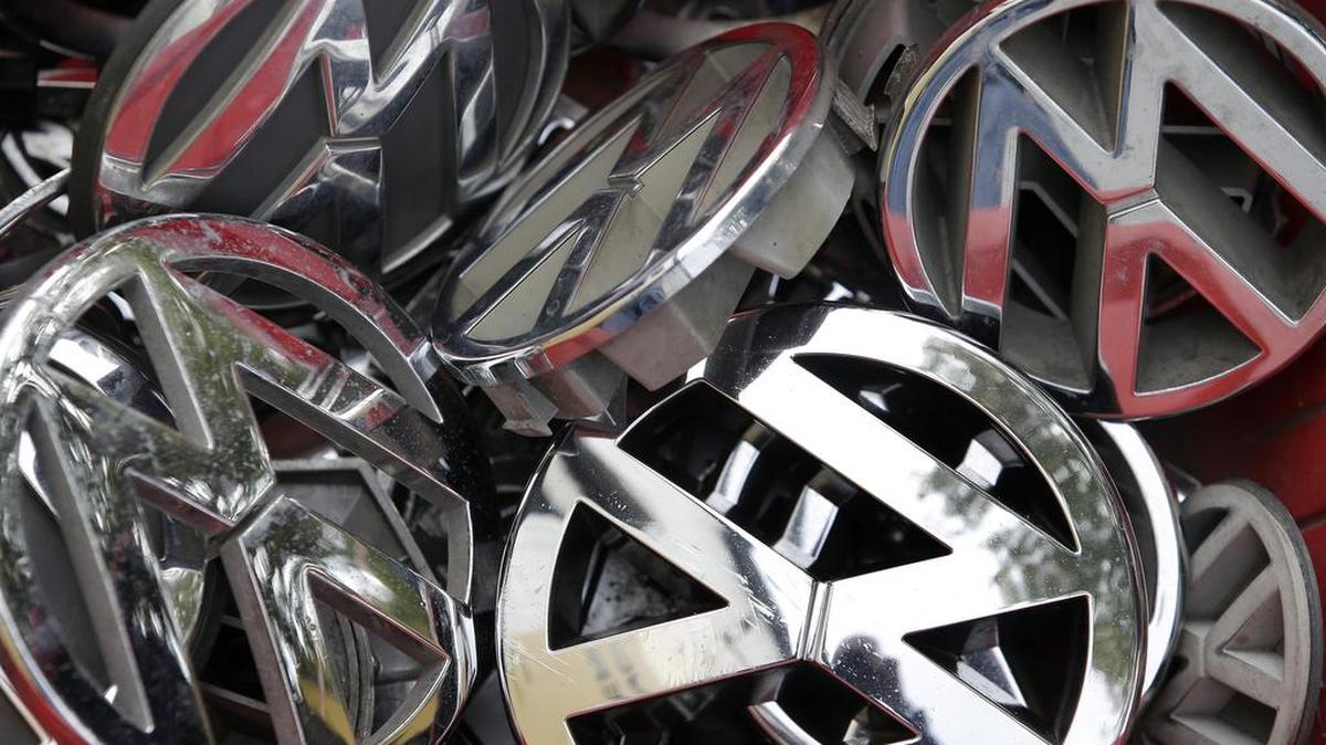 In this Sept. 23, 2015 file photo Volkswagen ornaments sit in a box in a scrap yard in Berlin. Federal authorities are suing Volkswagen over emissions-cheating software found in nearly 600,000 vehicles sold in the United States.