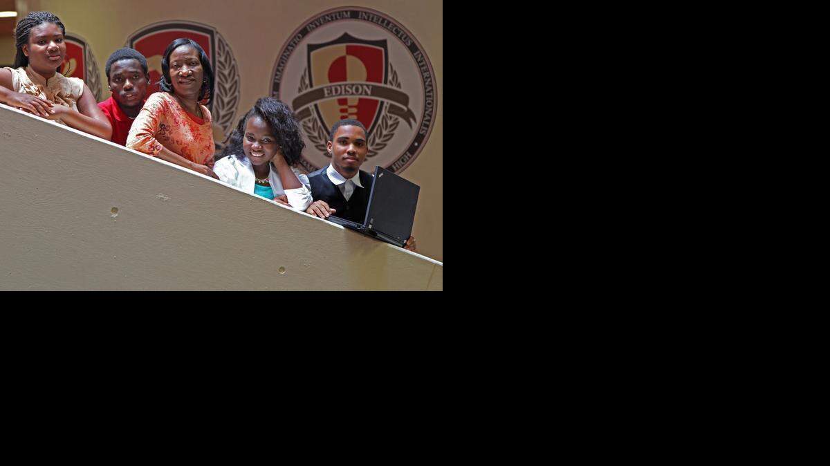 
THE WINNERS: Miami Edison Senior High teacher Yolette Mezadieu, center, is photographed with her team of students: Franceline Pierre-Louis, Evanson Telisme, Gerlannda Asse and Frantz Senat. They who won the Business Plan Challenge high school track for their business plan, "Word Avenger." 
