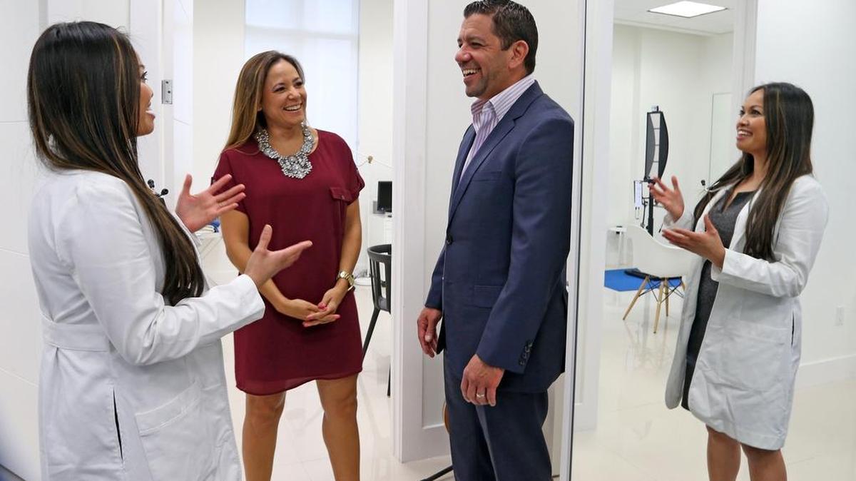 Dr. Dulce Mascarinas talks with Paola and Alain Fernandez, who won first place in the Business Plan Challenge FIU Track for ValueDOC — a free health and wellness marketplace for cash patients.