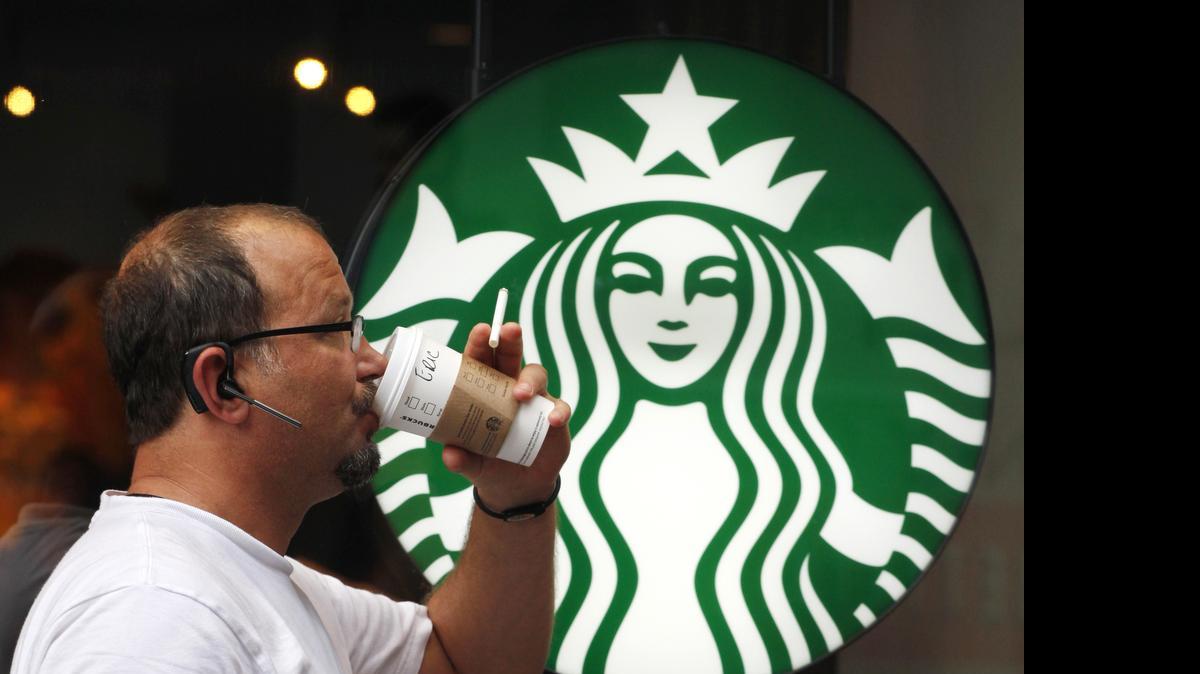 
In this July 11, 2013 file photo, a man drinks a Starbucks coffee in New York. Starbucks says it’s hiking prices again starting Tuesday, July 7, 2015, with the increases ranging from 5 to 20 cents for most affected drinks. 
