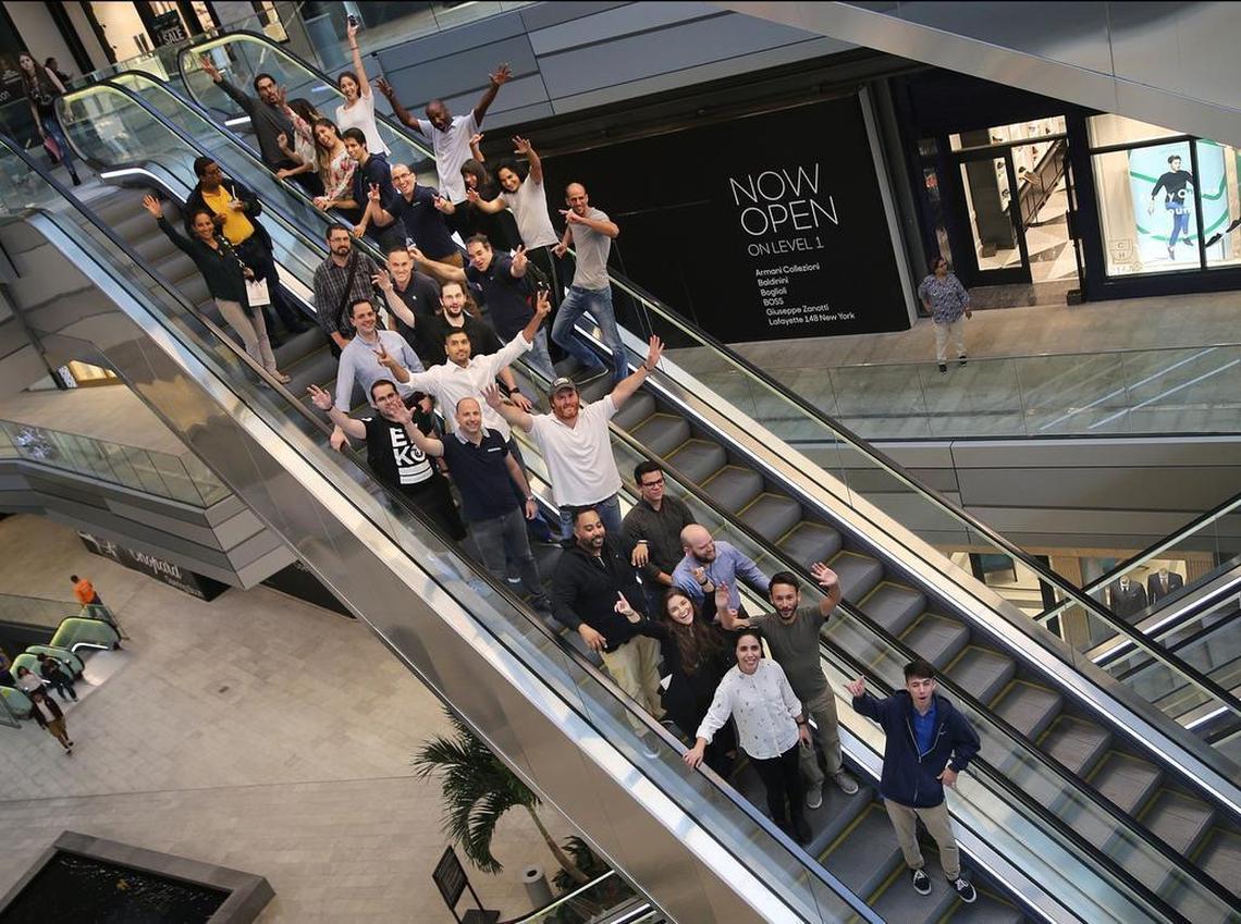 Adam Boalt (wearing a hat-white shirt), posed with his staff on the escalators (going up and down) at the office of his new business venture goWorks located at WeWork at Brickell City Centre in Miami. He is starting his third company in South Florida, after successfully launching, growing and selling two others, for BIZ Monday, on Tuesday June 06, 2017.