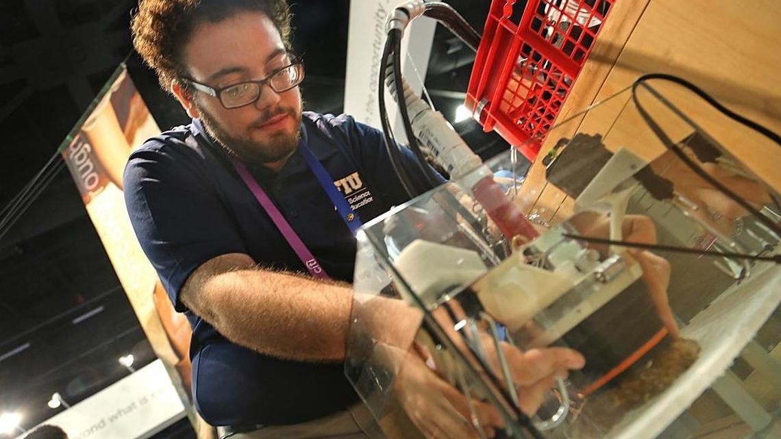 FIU coral biologist Gabriel Arias demonstrates a device that monitors the growth of coral in real time.