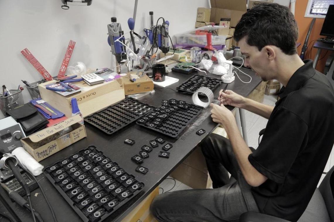 Assembly Engineer Robbie Fernandez puts together one of the wearable units at CarePredict headquarters in Plantation, Fla. on Nov. 10, 2017. CarePredict was founded by Satish Movva.
