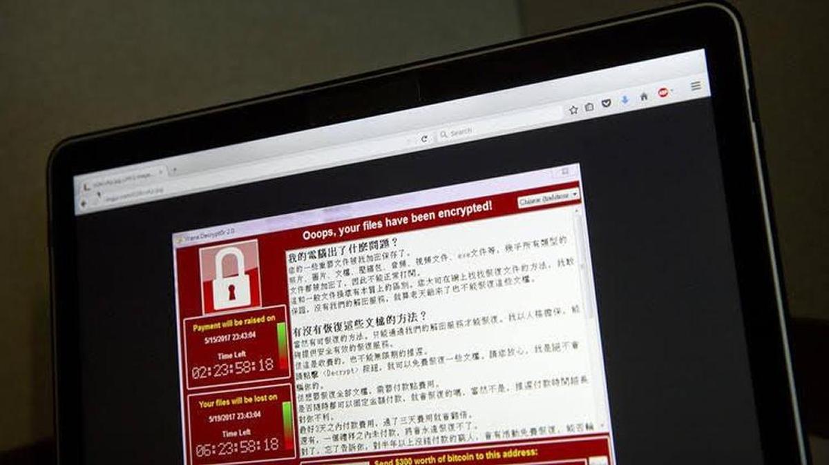 A screenshot of the warning screen from a purported ransomware attack, as captured by a computer user in Taiwan, is seen on laptop in Beijing on Saturday. Thousands of companies were hit with a huge ransomware attack over the weekend that locked up computers and held users' files for ransom in hospitals, companies and government agencies.