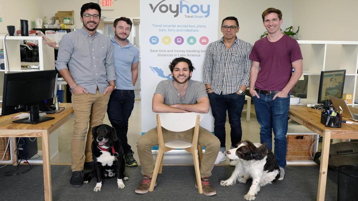 From left: Ignacio Vial, Mateus Rocha, Jake Moskowitz (seated) CEO, Juan Arredondo, and Roger Robinson at the offices of Voyhoy on June 22. Voyhoy, which recently won the big prize at eMerge Americas, has a travel app where people can buy tickets for Latin American travel on bus, flight, ferry and train — sometimes all in the same trip in one place online.