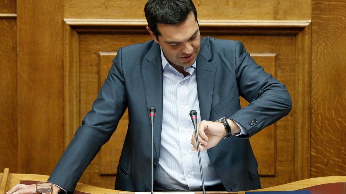 
Looks like it’s time for that bailout: Greek Prime Minister Alexis Tsipras checks his watch as he speaks to a parliamentary session in Athens, Friday, Aug. 14, 2015. Greek lawmakers approved their country’s draft third bailout in a parliamentary vote Friday that relied on opposition party support and saw the government coalition suffer significant dissent.
