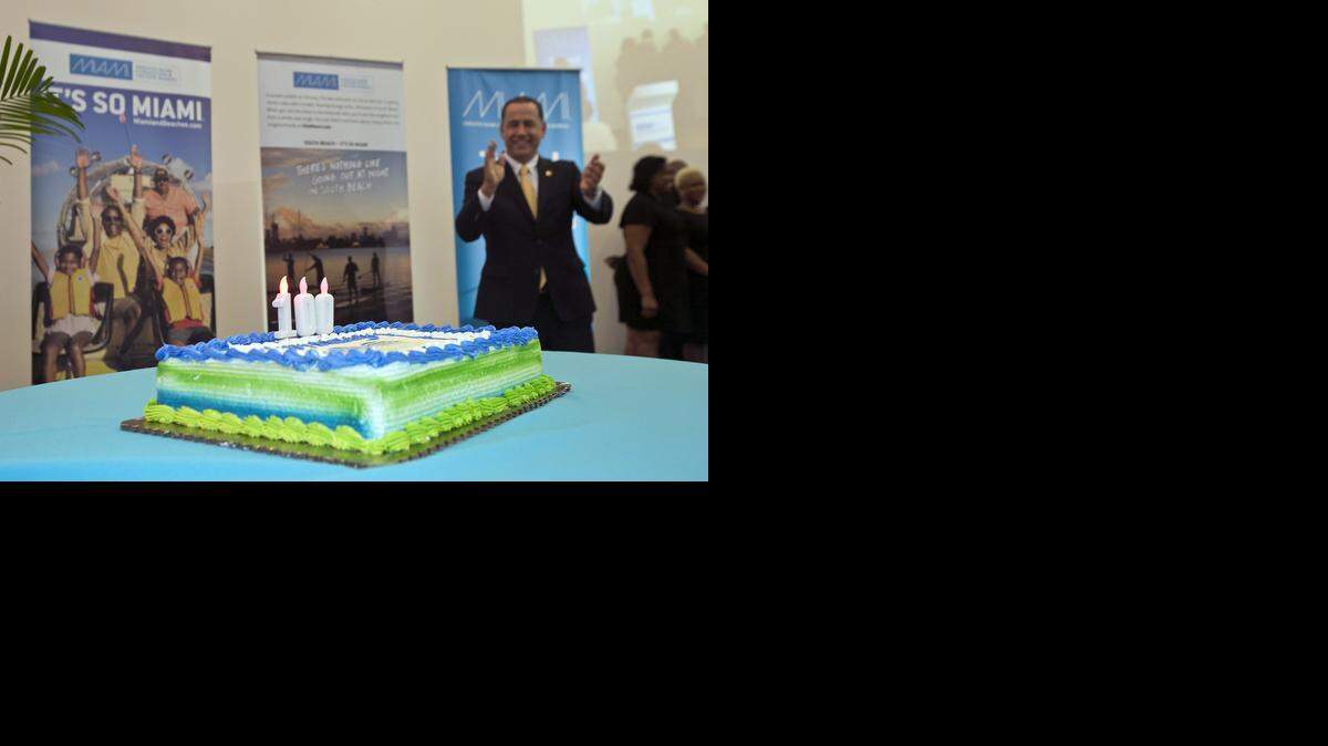 
CENTENNIAL PLANS REV UP: A choir sings ‘Happy Birthday’ to Miami Beach as Miami Beach Mayor Phil Levine applauds during the Greater Miami Convention & Visitors Bureau’s annual meeting at the Pérez Art Museum Miami on Monday. The official 100th birthday is next year, but will be well underway the next time the GMC&VB has its annual meeting. 
