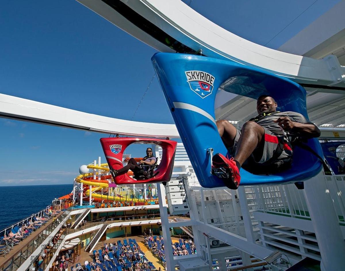 Guests onboard the Carnival Vista SkyRide, a suspended bike ride around an 800-foot track about150 feet above the sea.