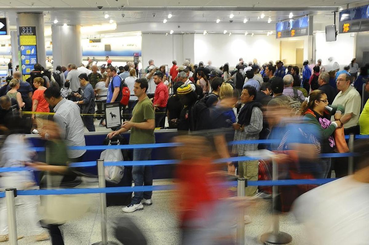 Local and international travelers wait in line for the security checkpoint at the Miami International Airport on May 26, 2016. Miami has the longest wait line among the busiest airports in the country with an average of 27 minutes.