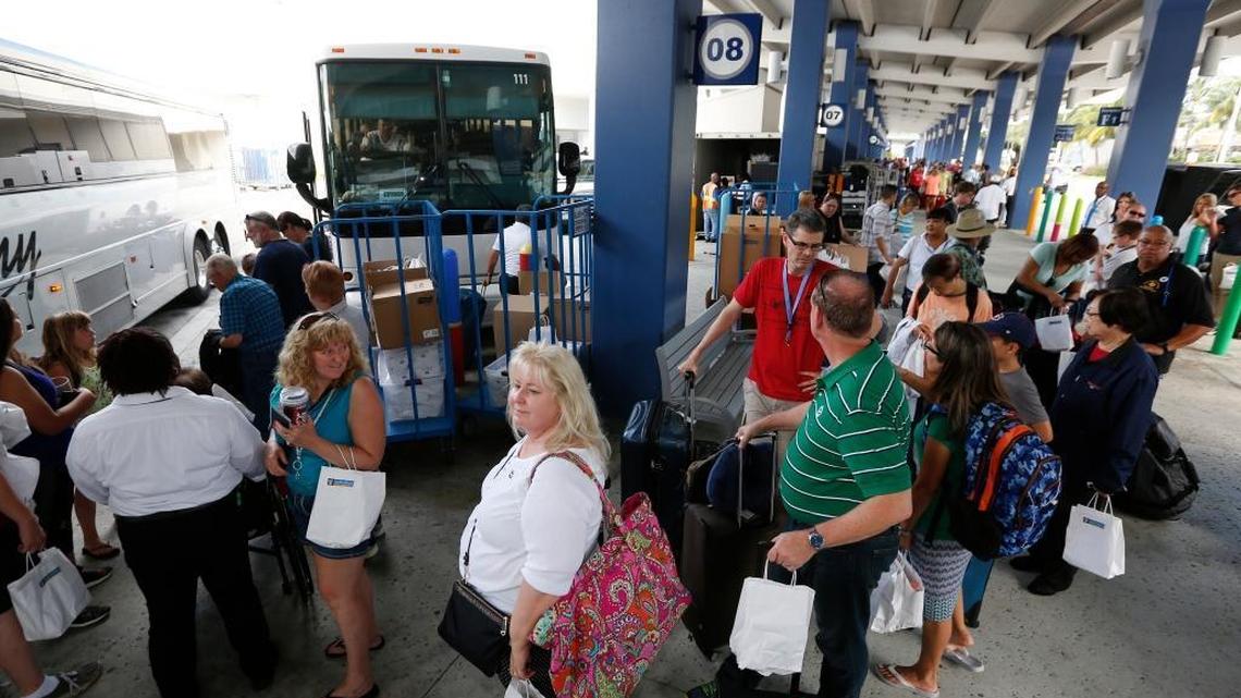 Cruise ship passengers line up for ground transportation after having disembarked from Royal Caribbean International's Liberty of the Seas, Tuesday, Aug. 29, 2017, at PortMiami in Miami. The Galveston, Texas-based cruise ship was scheduled to return to the city Sunday but was diverted to Miami, because of Hurricane Harvey.