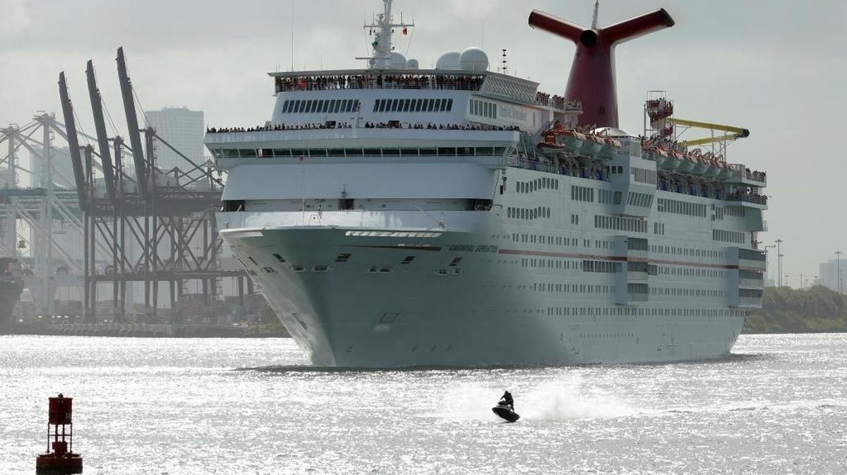 In this Monday, June 20, 2016, photo, a jet skier passes in front of the Carnival Sensation cruise ship as it leaves PortMiami.