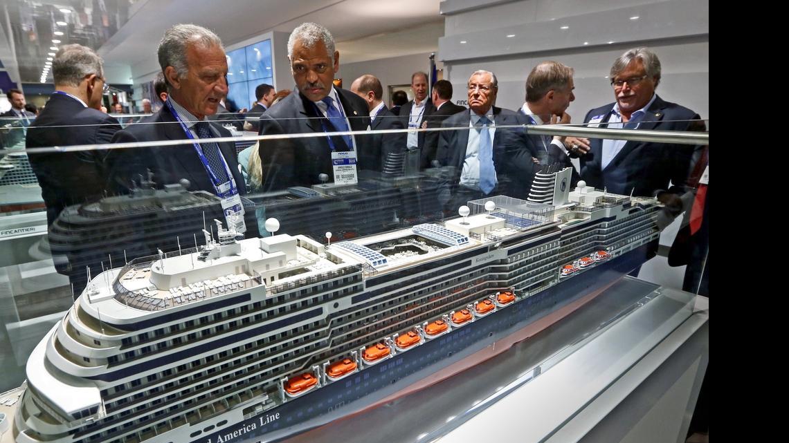 
Carnival Corp. on Monday announced details about four new ships on order. In this file photo from March, Fincantieri chairman Vincenzo Petrone and Carnival Corp. CEO Arnold Donald look over a model of a Holland America Line cruise ship with the company’s David Dingle and Micky Arison seen at right during the Cruise Shipping Miami conference. 
