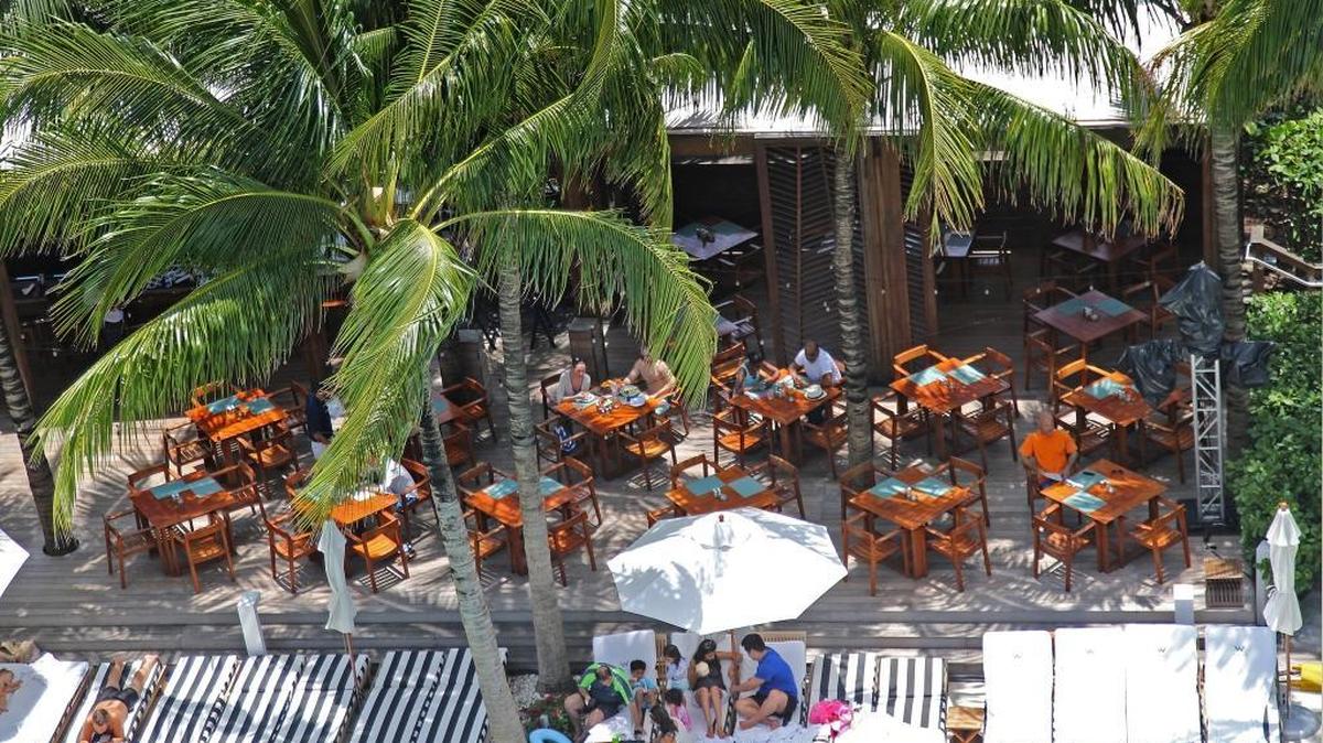 Guests of the W South Beach relax poolside. More South Florida hotels are offering staycation deals to Florida residents than ever before this summer.