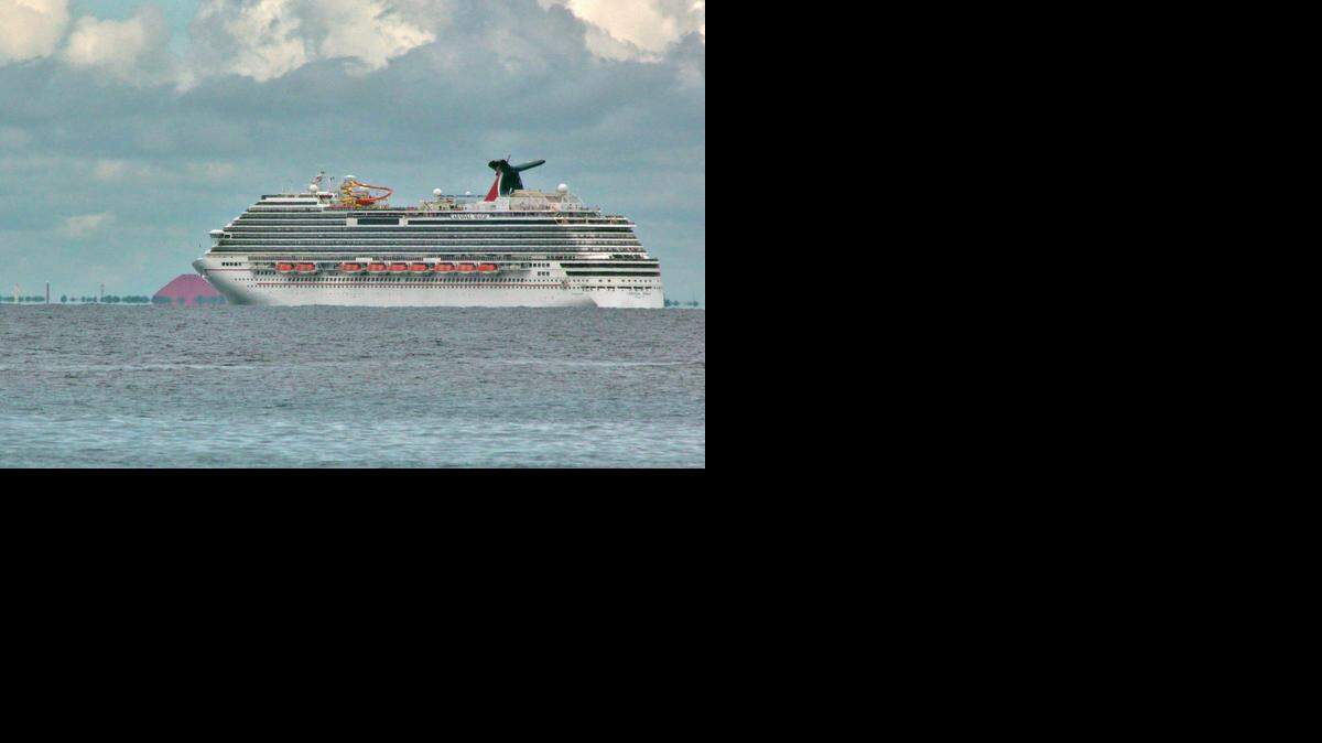 
The Carnival Magic waits off the coast of Cozumel to dock Friday morning. The cruise line decided to send the ship back to its home port in Galveston when it was discovered it was carrying a health care worker who may have handled lab samples from the deceased Ebola-infected man in Dallas.
