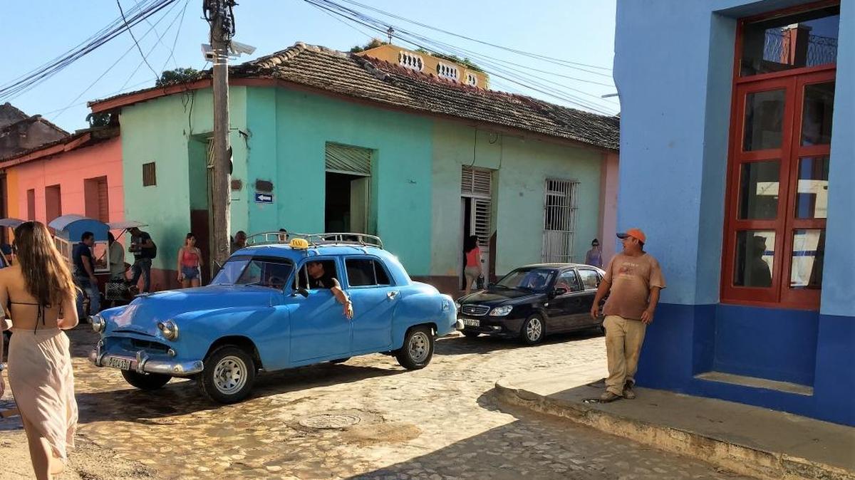 A classic car on a cobblestone street in Trinidad, Cuba.