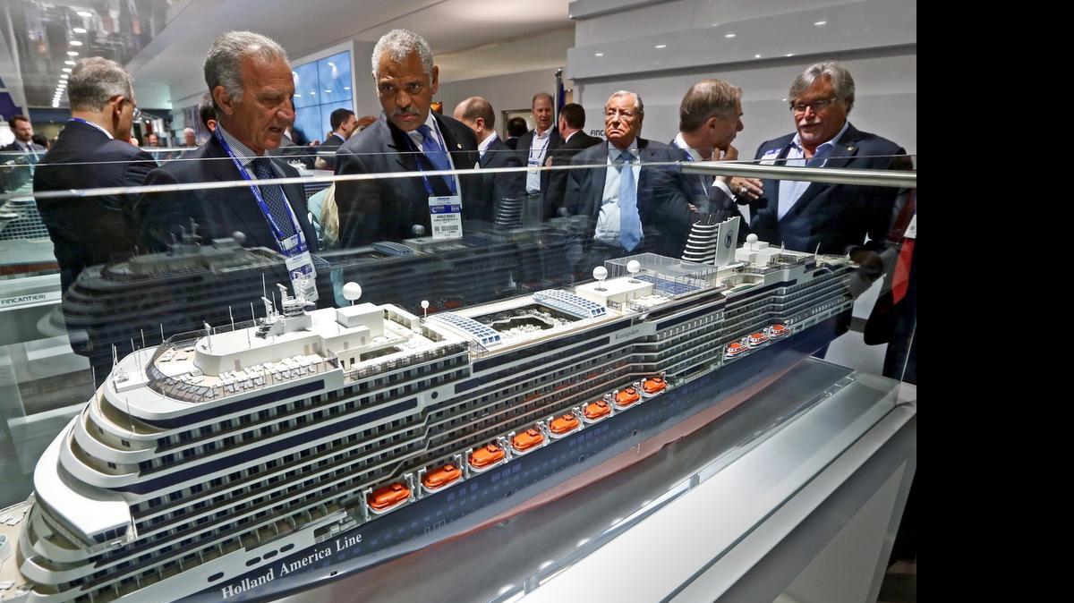 
Fincantieri chairman Vincenzo Petrone and Carnival Corp. CEO Arnold Donald look over a model of a Holland America Line cruise ship with the company’s David Dingle and Micky Arison seen at right during the Cruise Shipping Miami conference in March. Carnival is sending ships built by another company, Meyer Werft, to AIDA Cruises and Costa Cruises.
