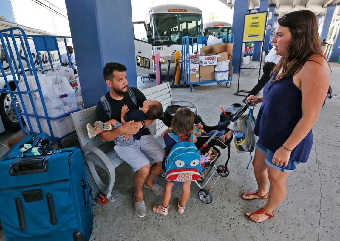Will Agnor, seated, of College Station, Texas, his wife Aubrey, right, and three children wait for transportation after having disembarked from the Royal Caribbean International cruise ship Liberty of the Seas, Tuesday, Aug. 29, 2017, at PortMiami in Miami. The Galveston, Texas-based cruise ship was scheduled to return to the city Sunday but was diverted to Miami, because of Hurricane Harvey.