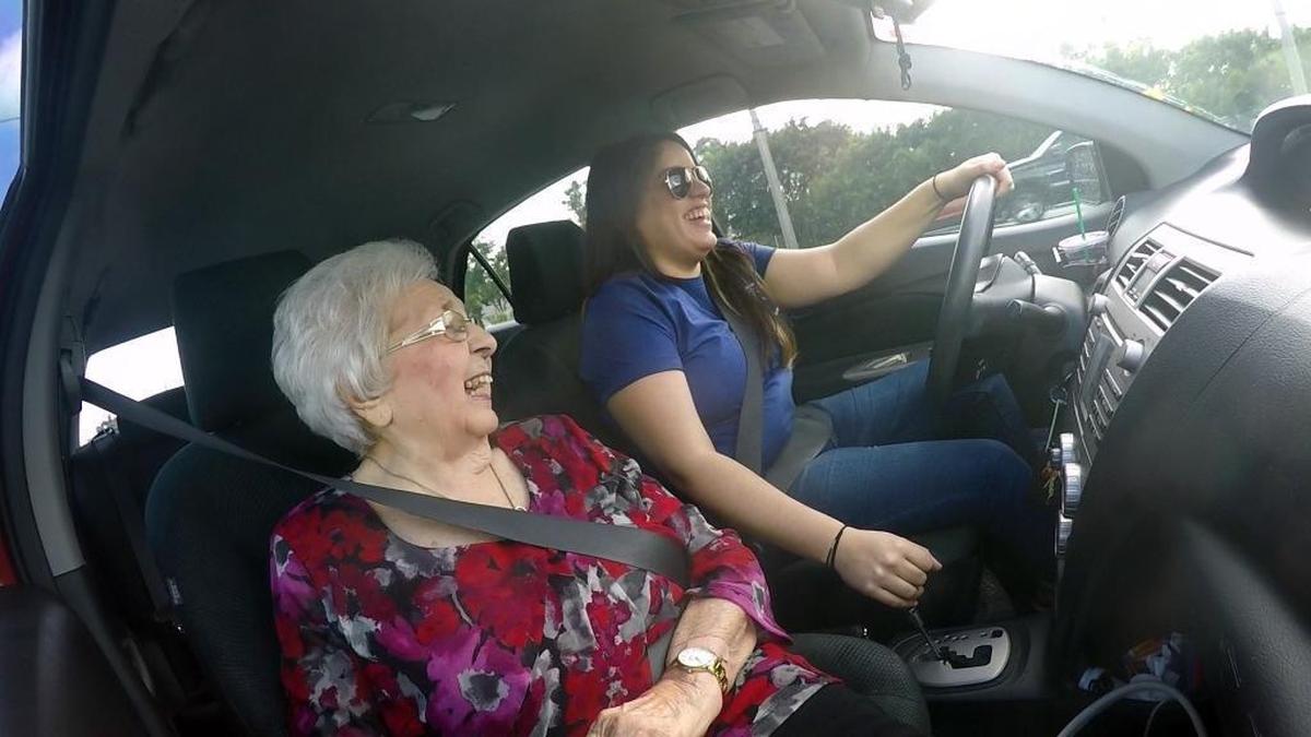 92-year-old Olga DeMartino laughs with her Papa Pal driver, Valeria Sosa, 26, as they return from DeMartino’s hair appointment Nov. 14, 2017. Sosa works for Papa, the startup that provides “grandkids on demand” to assist elderly customers.