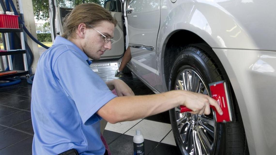 An employee details a car at Rising Tide Car Wash in Parkland in 2013.