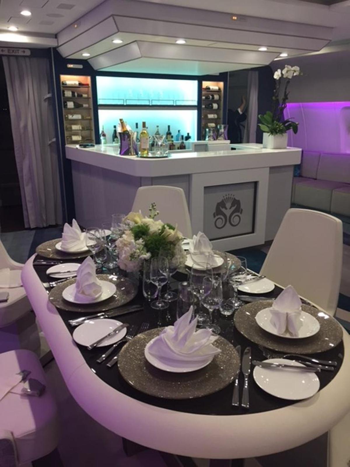 Tables in the tea lounge / bar aboard Crystal Skye charter aircraft can flip over to reveal electronic gambling tablets.