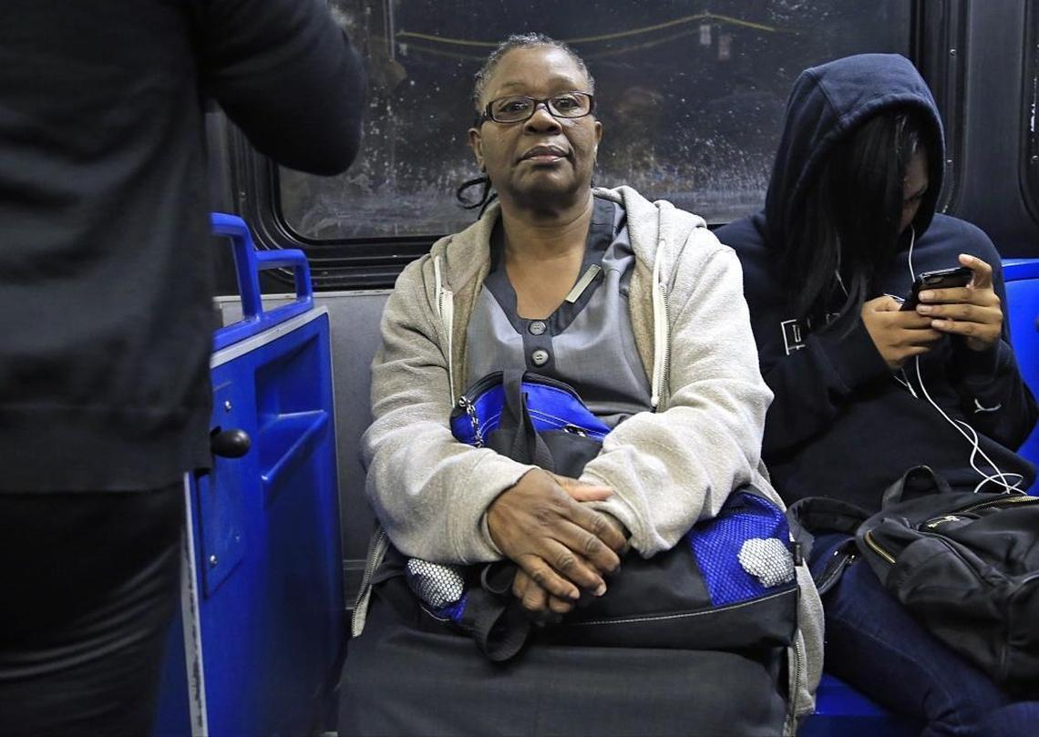 Fontainebleau housekeeper Odelie Paret, center, leaves her home before the break of dawn to catch two buses to her job on Miami Beach. Here, Paret sits on the first bus, the 27, in late April. Her morning commute takes about an hour. In the afternoon it can take up to three.