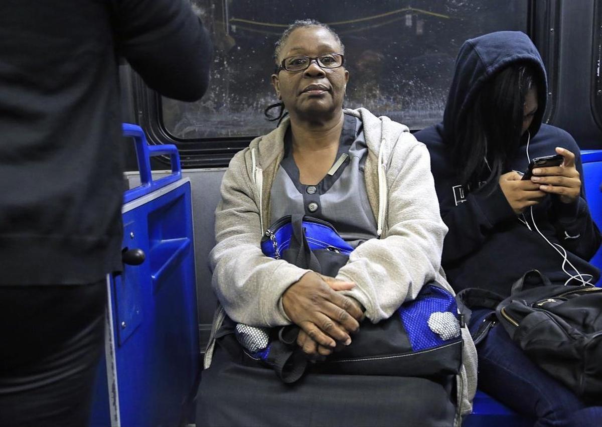 Fontainebleau housekeeper Odelie Paret, center, leaves her home before the break of dawn to catch two buses to her job on Miami Beach. Here, Paret sits on the first bus, the 27, in late April. Her morning commute takes about an hour. In the afternoon it can take up to three.