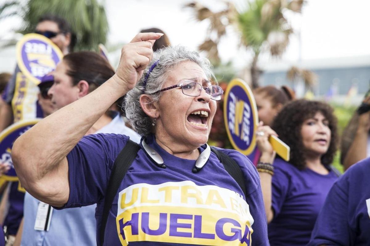 Zoila Matienzo joins an airport strike against Ultra Aviation’s healthcare policy at Miami International Airport in Miami on June 29, 2017.