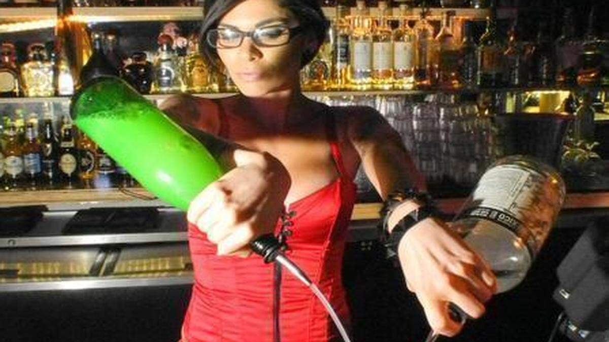 
Mixologist Cami Figueras pours some drinks at the Radio Bar on Miami Beach in 2013.
