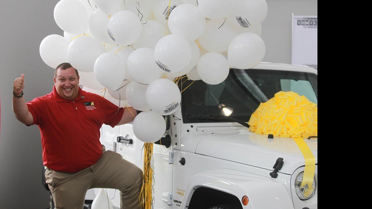 AutoNation, the nation’s largest car dealer and based in Fort Lauderdale, sold its 10 millionth vehicle this month. Darlan Peña, above, sold a Jeep Wrangler at the Pembroke Pines dealership to Daisy Gomez, who is director of provider relations for Baroma Health Partners; she bought a 2015 Jeep Wrangler for her daughter.  AutoNation sales were up 5 percent this month compared to May of last year. Sales in the retail vehicle industry were up 12 percent in Florida and 2 percent overall.
