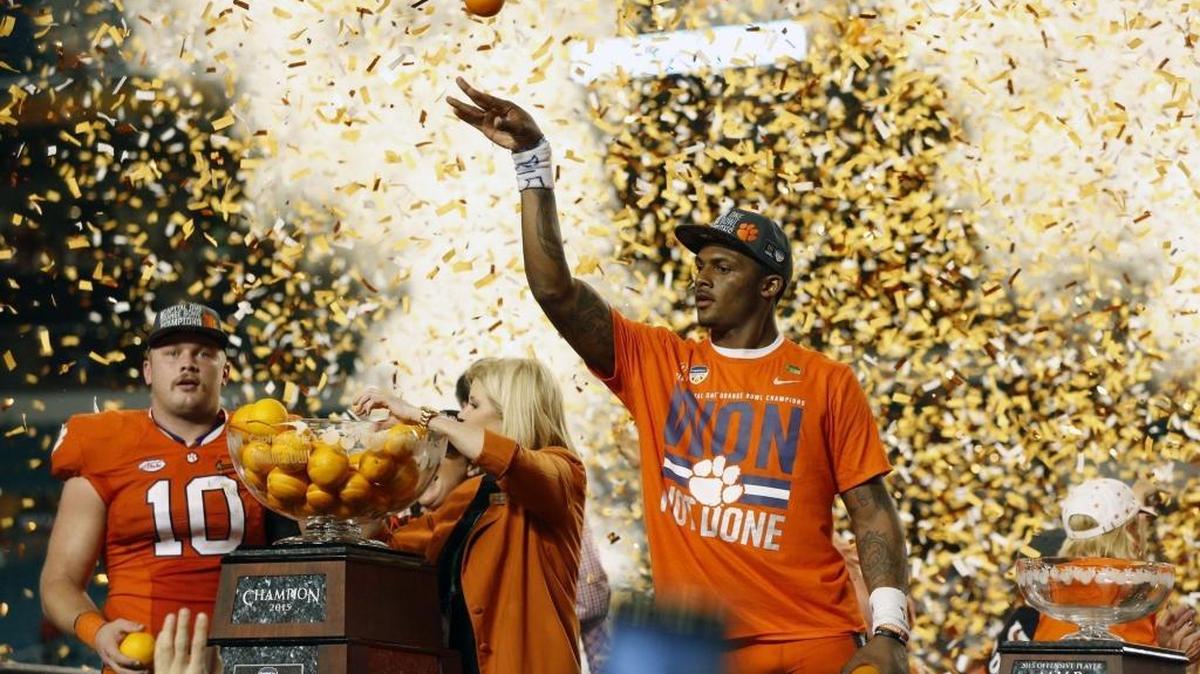 Defensive MVP Clemson Tigers linebacker Ben Boulware (10) and offensive MVP quarterback Deshaun Watson (4) at right, after Clemson defeats Oklahoma during the Orange Bowl game at New Miami Stadium on Thursday, December 31, 2015. Also pictured: former Orange Bowl president and chair Lee Stapleton (middle).