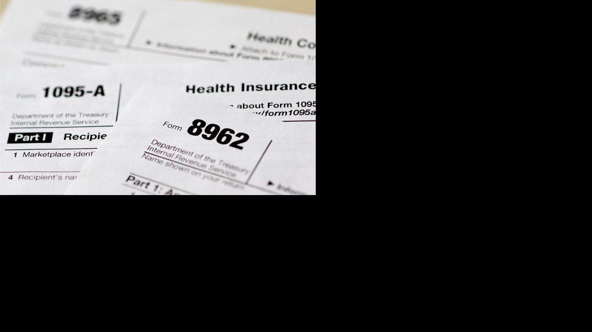 In this photo taken Aug. 21, 2014, health care tax forms 8962, 1095-A, and 8965, are seen in Washington. Being uninsured in America will cost you more in 2015. In 2015, all taxpayers have to report to the Internal Revenue Service for the first time whether or not they had health insurance the previous year. Most will check a box. It’s also when the IRS starts collecting fines from some uninsured people, and deciding if others qualify for exemptions. (AP Photo/Carolyn Kaster)