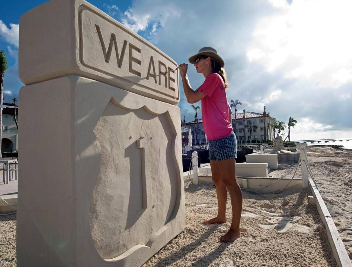 Local sand sculptor Marianne van den Broek unveils the “We Are 1” sculpture on the beach at the Casa Marina, A Waldorf Astoria Resort, in Key West.