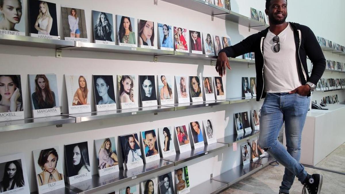 Rasheed Alli, founder of DAS Model Management, leans on the display of model comp cards at his South Beach location, June 30, 2017. The company has signed more than 250 models in its first year of operation.