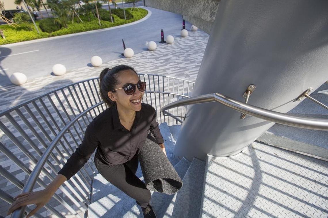 Jackeline Hauck, 26, from South Miami, climbs steps to ride down a new 93-foot-tall slide at Aventura Mall on Monday, Dec. 18, 2017. Aventura Slide Tower, which is free for anyone to use, is part of a three-story wing expansion at the mall. The move added new restaurants, retail stores and an outdoor fountain.