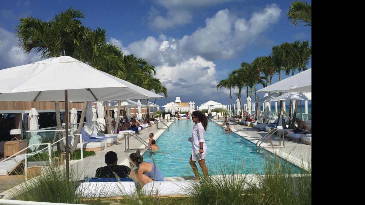 
Travelers enjoy the poolside of the 1 Hotel South Beach on a recent weekend. Locals can take advantage of summer prices this season. 
