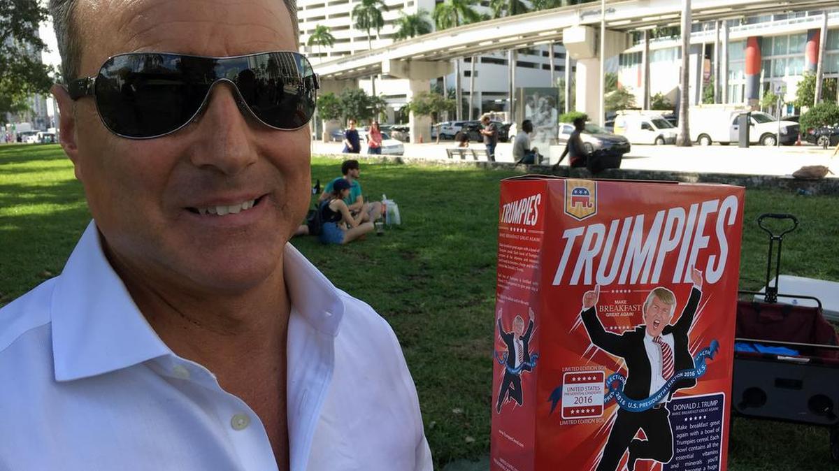 Santiago Cueto shows off a box of Trumpies outside a Donald Trump rally at Bayfront Park on Nov. 2.