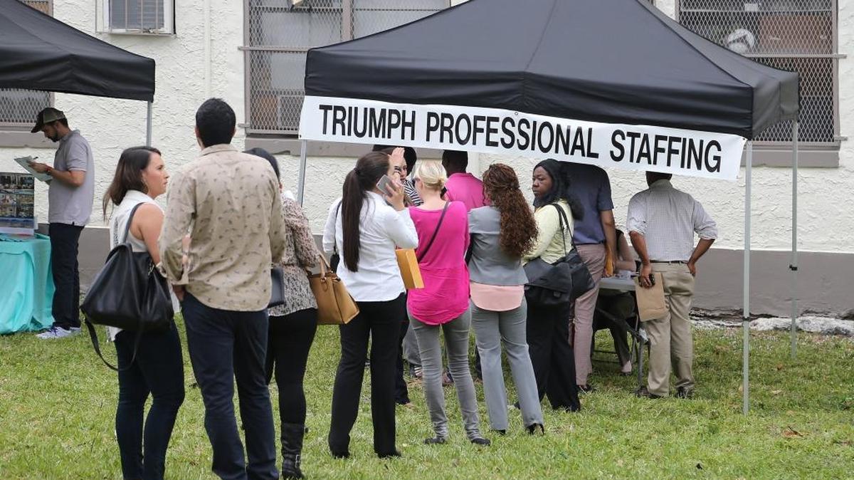 Job seekers line up at an employment fair in downtown Miami in 2016.