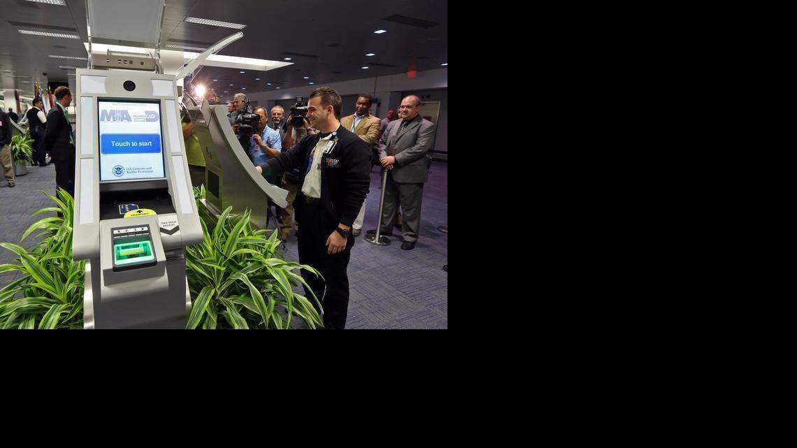 
MIA Operations Specialist Dayron Rodriguez demonstrates passport kiosks at Miami International Airport’s Terminal D in this 2013 file photo. 
