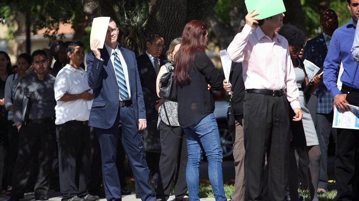 Job seekers line up outside the Shula Hotel & Golf Resort for a job fair in Miami Lakes.