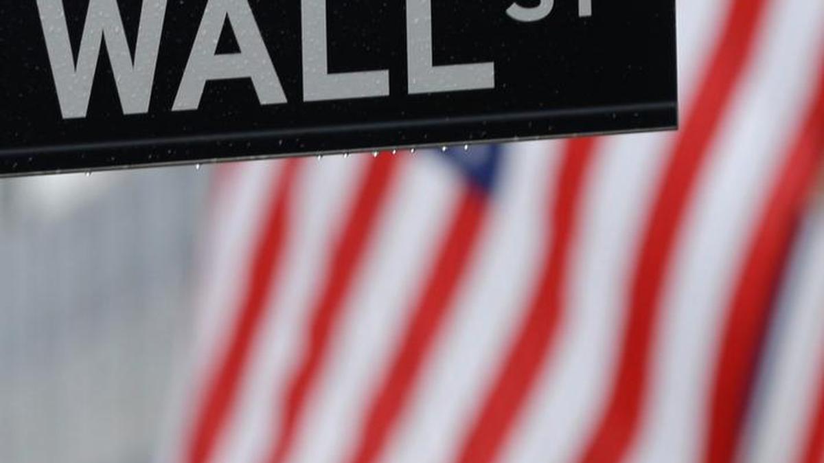 In this July 9, 2015 file photo, a Wall Street sign is seen near the New York Stock Exchange in New York.