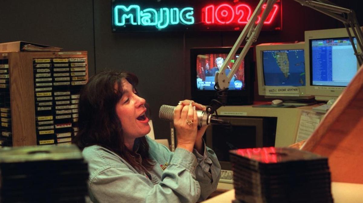 Magic 102.7 DJ Mindy Lang sings along to an oldie tune in 2000.