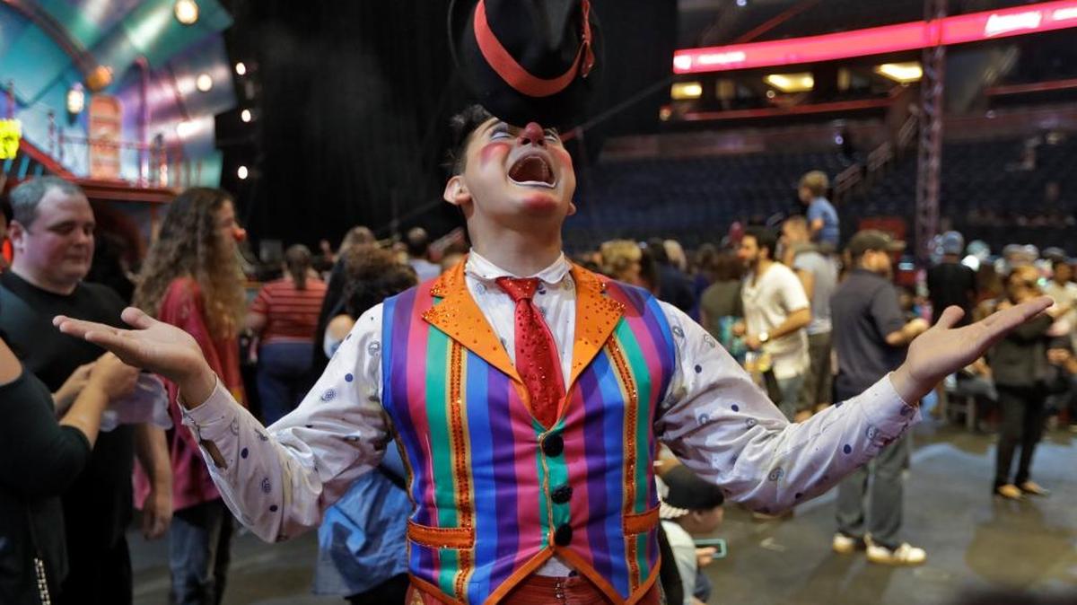A Ringling Bros. and Barnum & Bailey clown balances a hat on his nose during a pre show for fans Saturday, Jan. 14, 2017, in Orlando.
