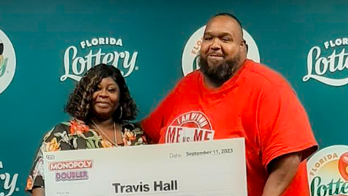 Travis Hall, pictured with his wife, spent $20 on a scratch-off ticket that was worth much more.