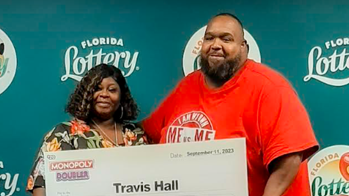 Travis Hall, pictured with his wife, spent $20 on a scratch-off ticket that was worth much more.