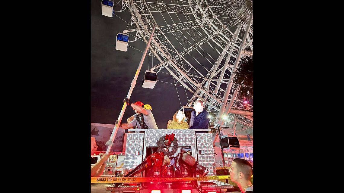 Rescuers scaled the wheel, which was sparking and smoking in videos.