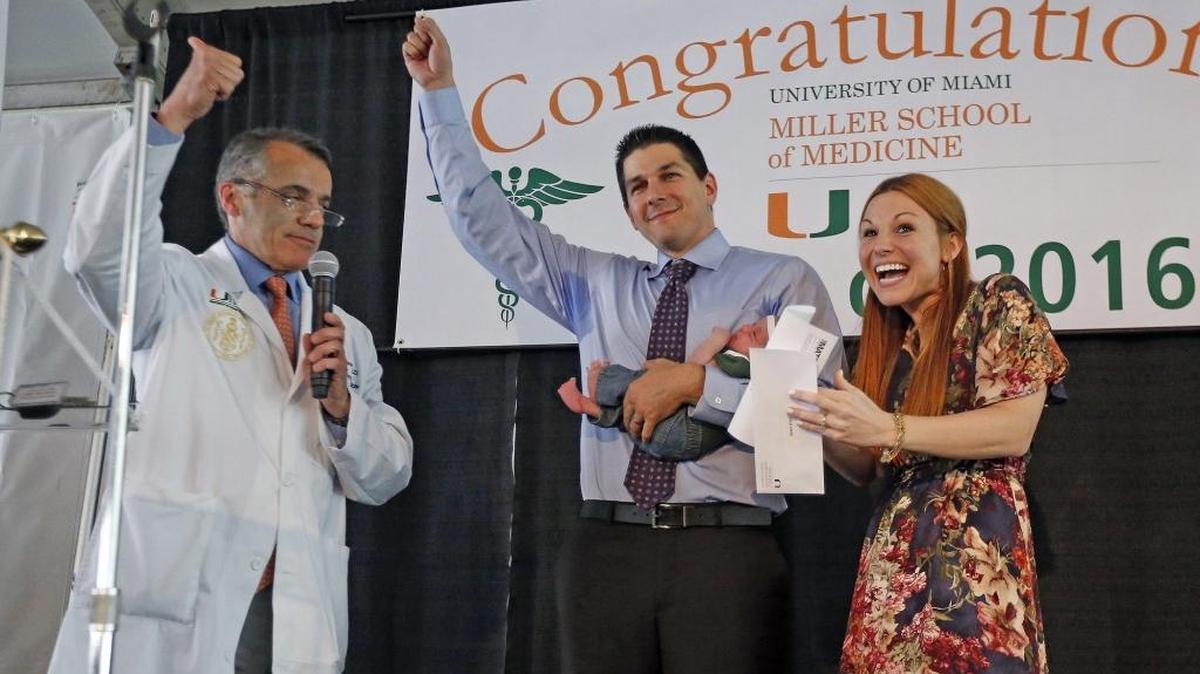 Dean Pascal Goldschmidt gives the thumbs up as Derek Estes with his wife Emily and their 3-week old baby Alexis learn he will serve his residency at Jackson Memorial Hospital, March 18, 2016. Goldschmidt will retire at the end of May after 10 years leading the medical school, UM announced on Thursday.