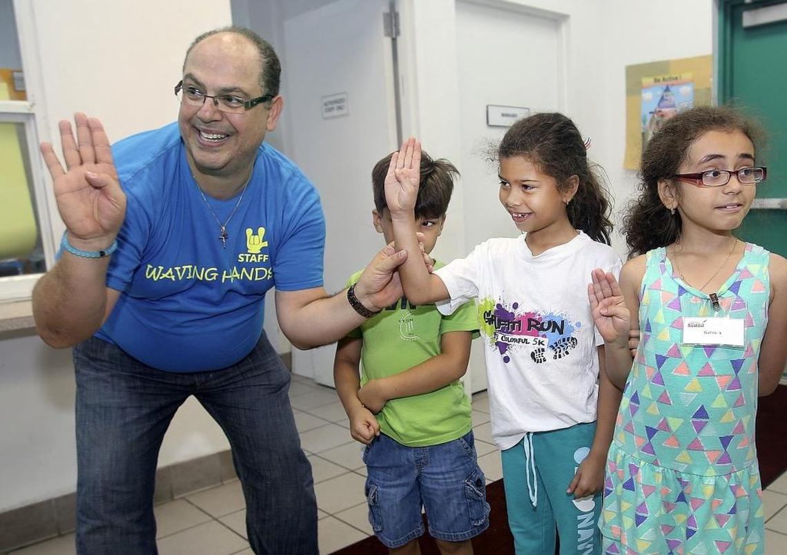 In this April 2016 photo, John Paul Jebian (left) teaches students to use American Sign Language as part of his group, Waving Hands, at Highland Oaks Park in Miami. Jebian won the right to sue Baptist Health South Florida for discrimination this week after an appeals court reversed a lower court’s earlier dismissal of his case. The appeals court’s opinion stated that hospitals have a legal requirement under the Americans with Disabilities Act to ensure that deaf patients have the same opportunity as patients who are not deaf to participate effectively in their medical care.