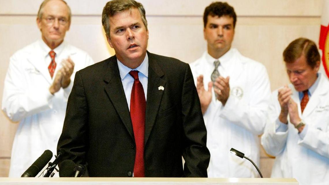 Florida Gov. Jeb Bush, center, pauses as he receives applause from Tampa-area doctors and hospital staff members during a speech on medical malpractice, Friday, July 11, 2003 at the H. Lee Moffitt Cancer Center and Research Institute.