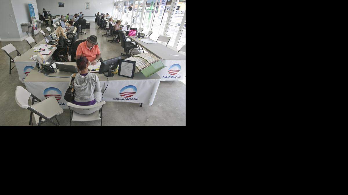 
Madelaine Carrazana, 46, discuss Obamacare options with insurance agent Arturo Aguiar at a UniVista Insurance agency in the Miami neighborhood of Flagami.
