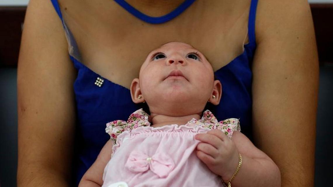 Maria Carolina Silva Floa, 20, looks down at her baby, Maria Gabriela Silva Alves, who was born with microcephaly, as they wait for her physiotherapy appointment at Pedro 1 Municipal Hospital in Campina Grande, Brazil.